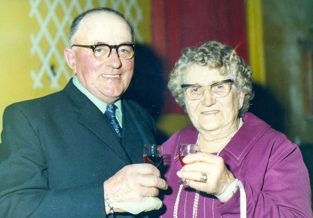 An elderly couple celebrating their 50th wedding anniversary in 1975, with glasses of sherry.