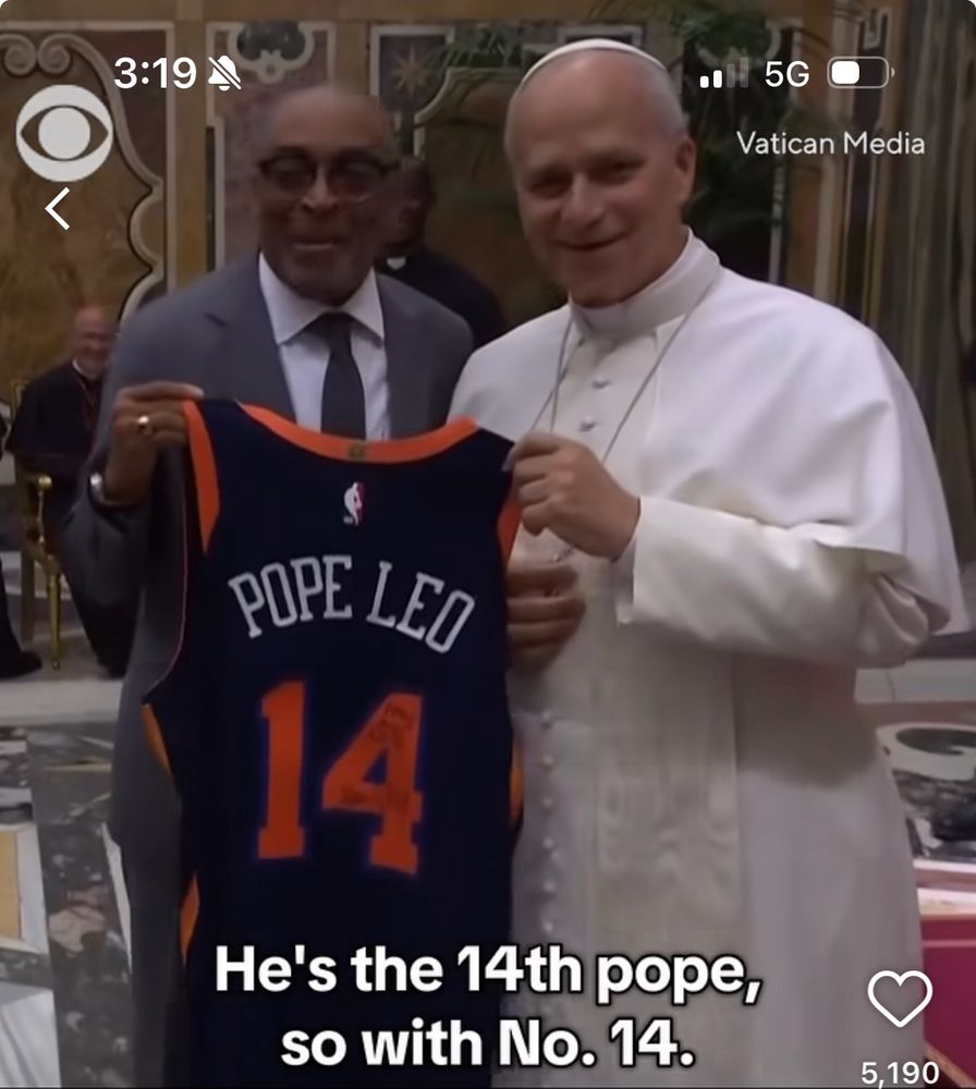 Spike Lee and The Pope holding up a Knicks jersey that says “Pope Leo” on it. 