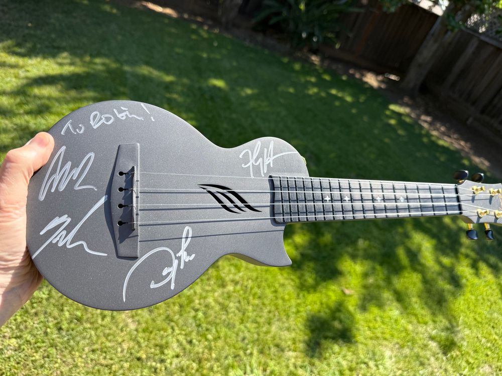 Small black ukulele signed “To Robin” in silver by the members of the band Everclear