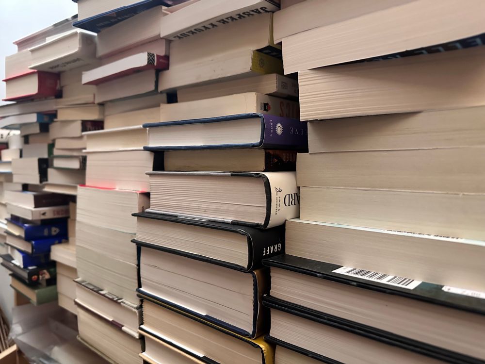 Stacks of books, stacks are photographed in a way so you can’t see the titles - just the bottom of the pages.