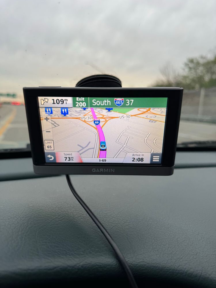 A GPS device in my car showing directions to take an exit onto Interstate 465 in 109 miles