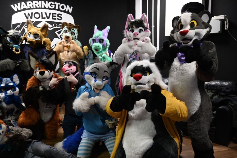 A group of fursuiters, posing for photos at a WarringtonFurs meet.