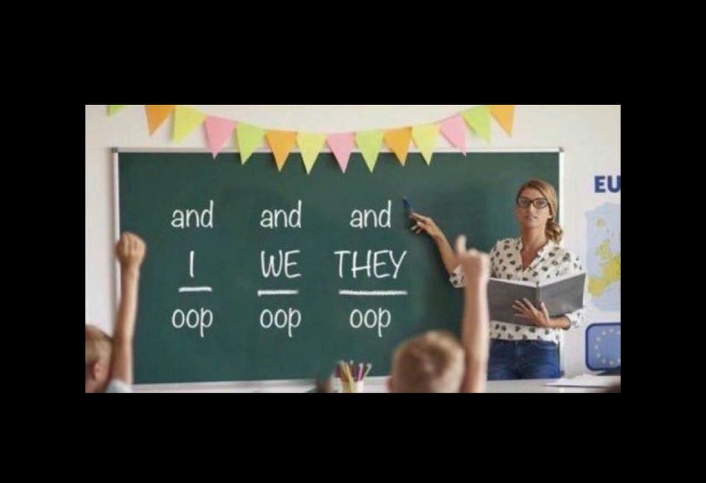 A teacher pointing to a blackboard that says:
And I oop 
And We oop
And They oop