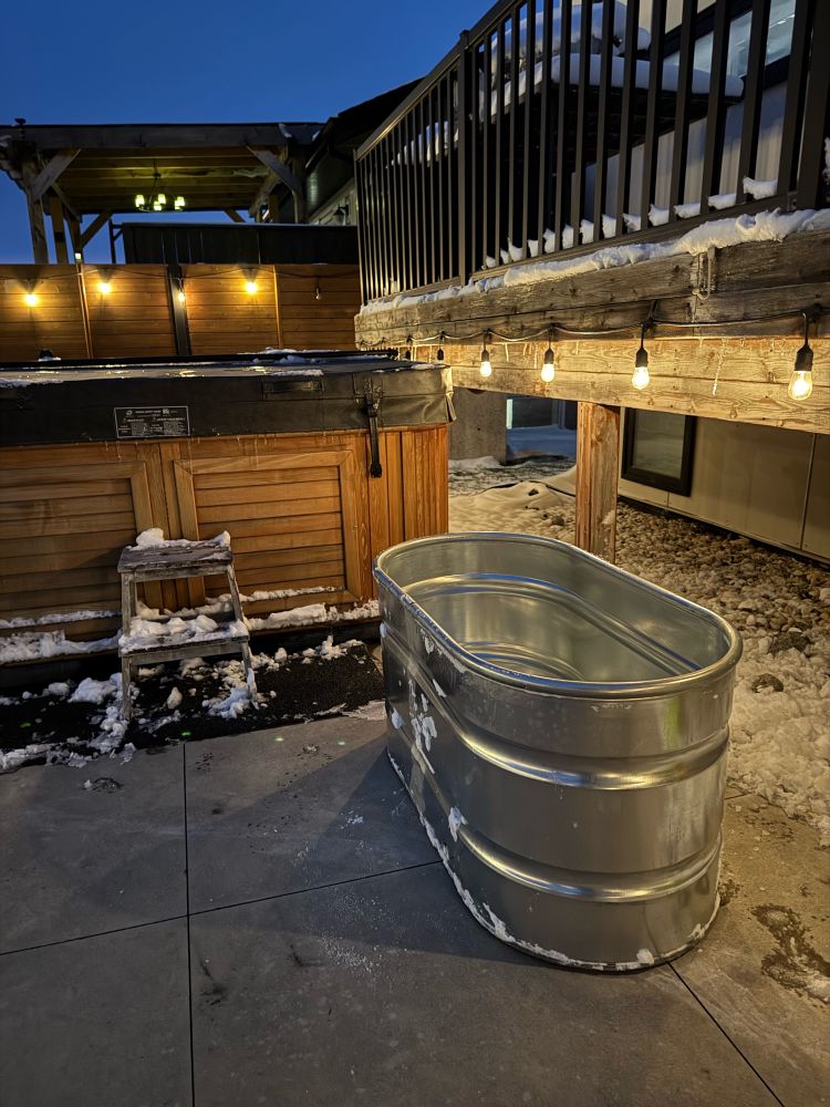 stock tank diy cold plunge tub in front of a hot tub