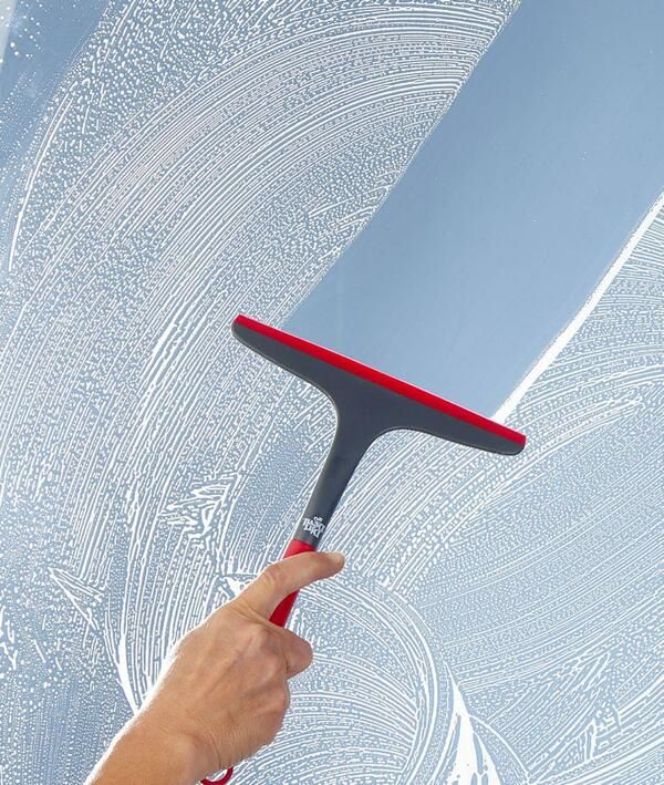 Window squeegee cleaning glass