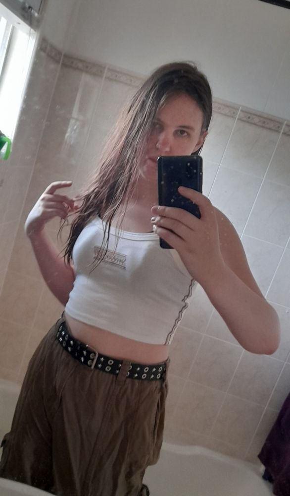 mirror selfie of me in a white top and olive green cargo pants