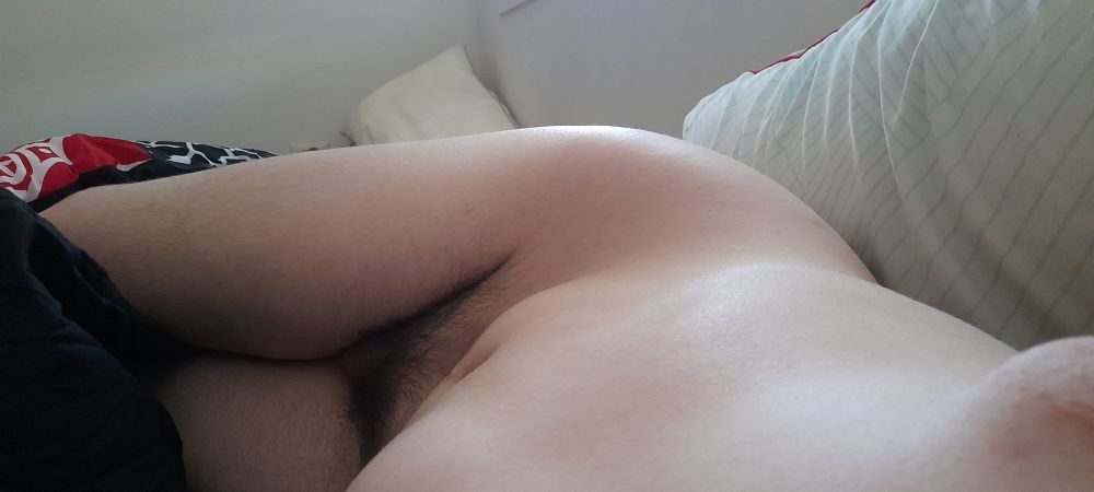 nude picture of me in bed on my side, you can see from my knees up to my tummy, with one tit peaking into frame. im using the angle to show of the curve of my hips