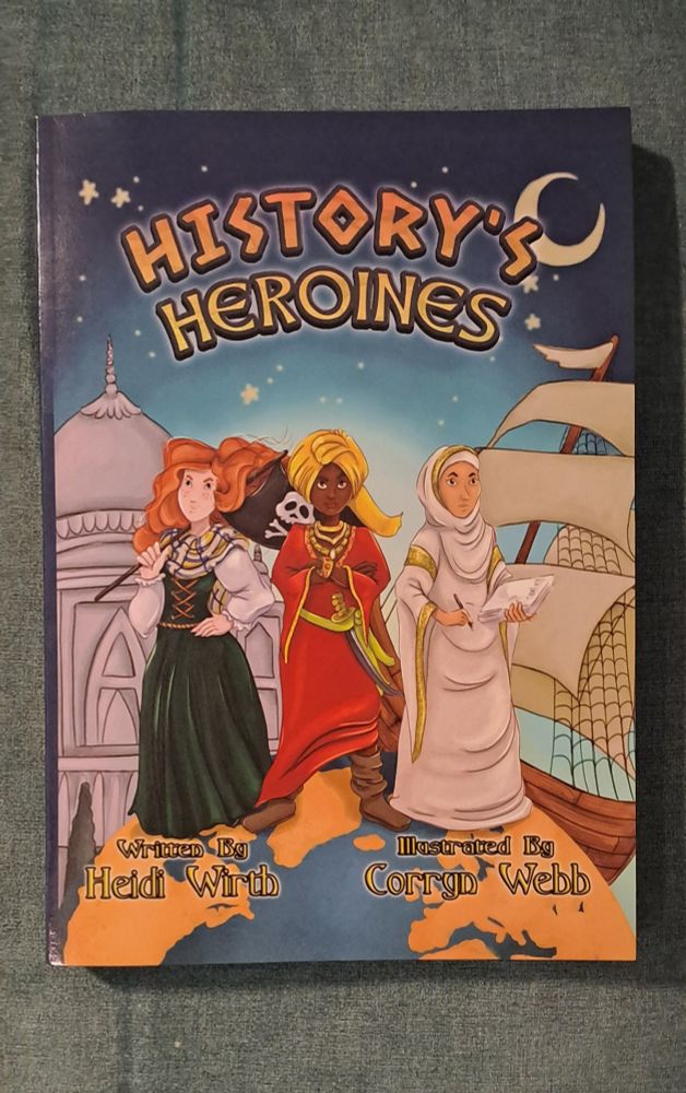 Image is a photo of the book, with the title History's Heroines. 3 women of different nationalities stand on tip of the world. The background is blue, with a building on the left and a ship on the right. 