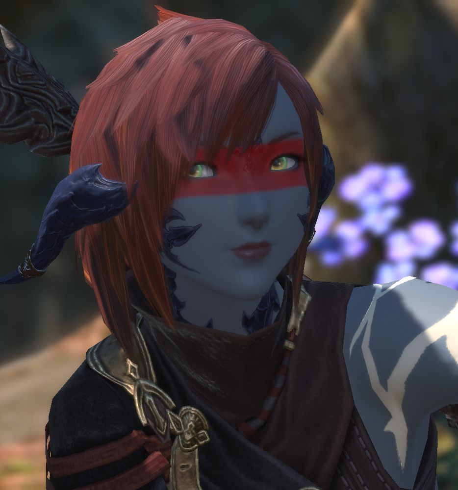 Tsetseg Qalli, a grey-skinned female xaela with red hair in a shaggy wolf-cut, swept back horns, and a red streak of paint across her eyes, wearing red-and-gold armour with an asymmetrical one-sleeved top. Her bare are is criss-crossed with white bodypaint. . She smiles to herself in front of some purple flowers.