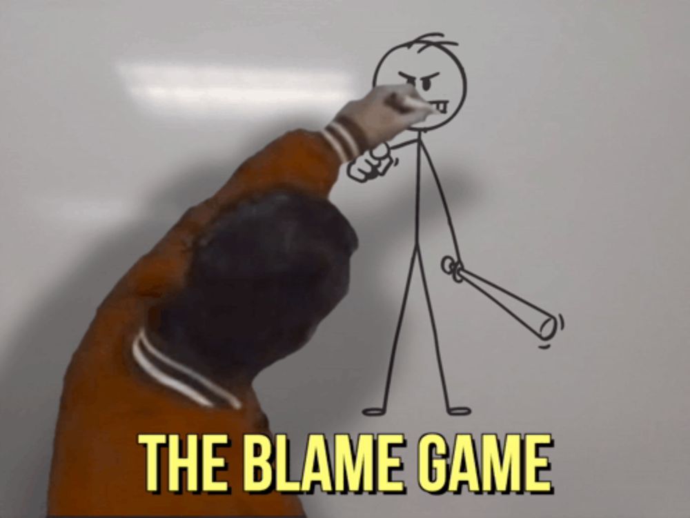 a person draws a stick figure with the words the blame game below