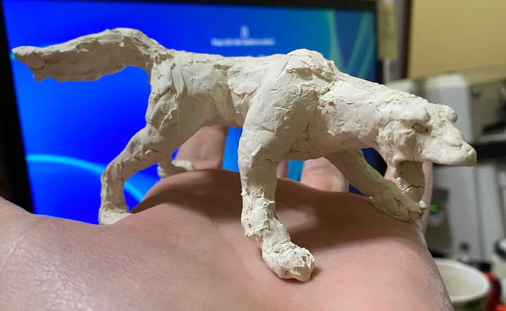 A small, incomplete clay sculpture of Aenocyon dirus 