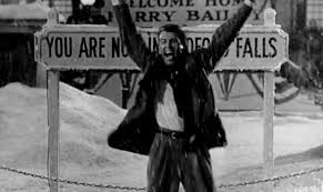 george bailey experiences the wonder of life and shares it by running through the town. in this photo he’s outside the “you are now in bedford falls” sign filled with glee in the 1946 film “it’s a wonderful life”