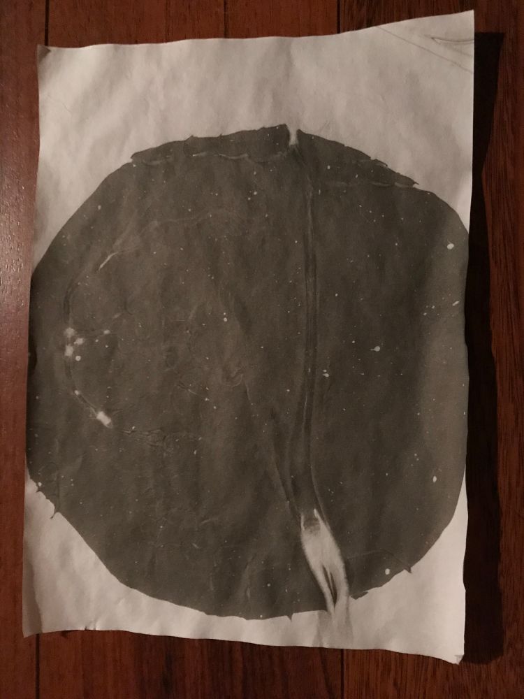 Abstract suminagashi print in black and white. It’s just a big black circle but with a little white escape smear, like a Q but more foreboding. 