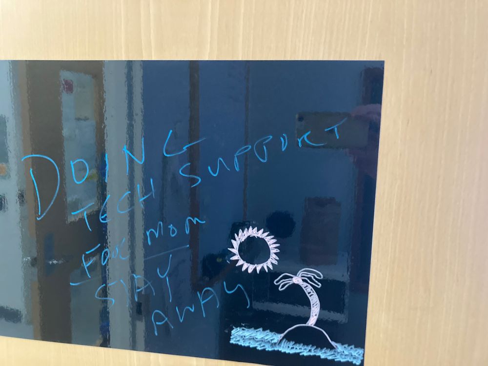 Sign on office door that says Doing tech support for Mom, stay away