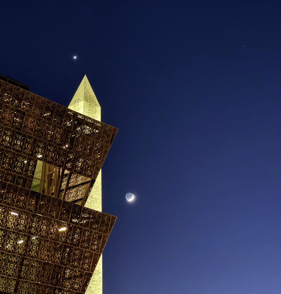 Photo Description

The tall white tower of the Washington Monument standing behind the corner of the NMAAHC building under the night sky with the moon and Venus. Credit: @NationalMallNPS