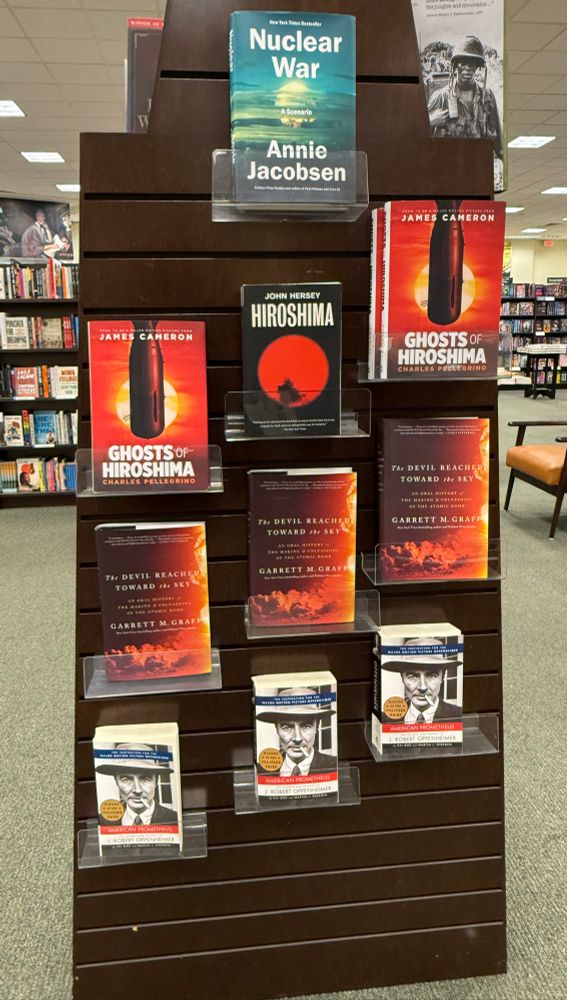 Display of books about Hiroshima, including several copies of The Devil Reached Toward The Sky by Garrett M. Graff. 