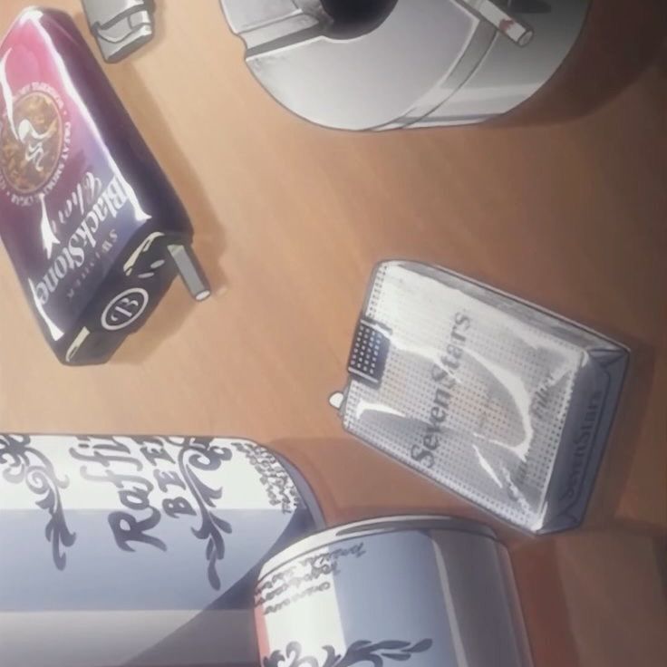 A still from the Nana anime, featuring cans of beer and two packets of cigarettes next to an ashtray. 