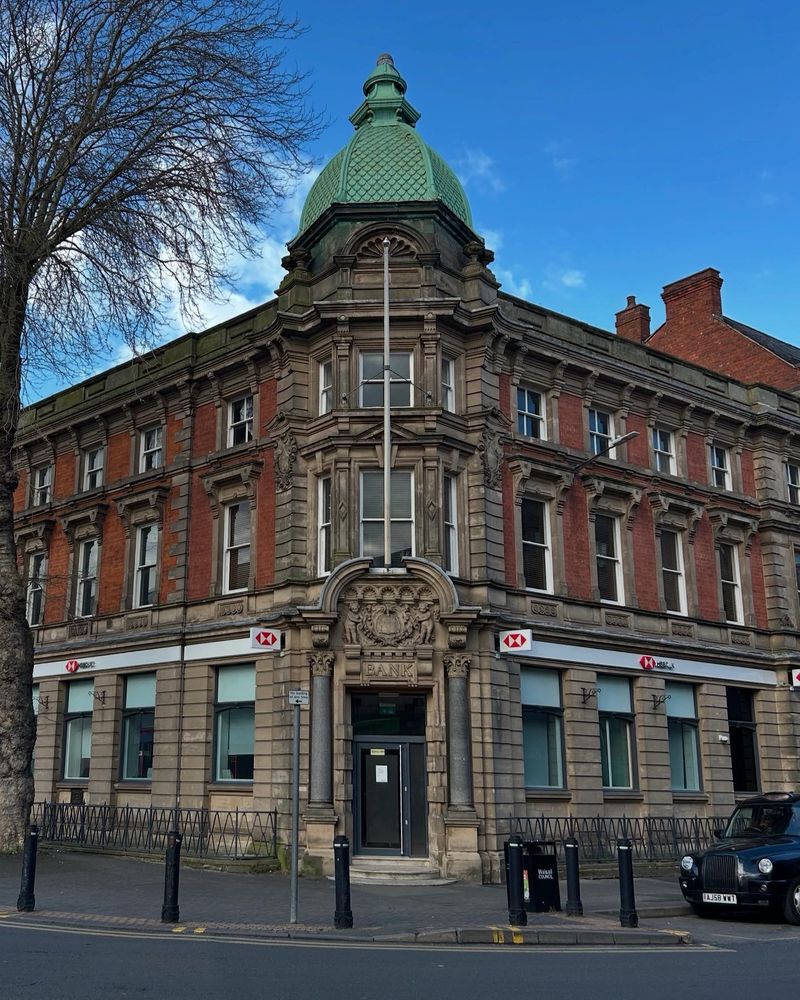 Corner building former Midland bank, red brick and stone dressing and mouldings, incorporating a second bank to the right