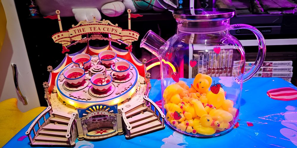 A picture of the Quacker teacups, which we built last year, and a glass teapot filled about halfway with Quackers. Some small and some bigger. 