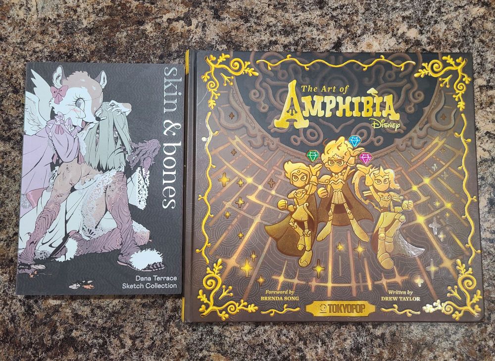 Two art books- Skin & Bones on the left, a sketch collection from Dana Terrace; and The Art of Amphibia on the left