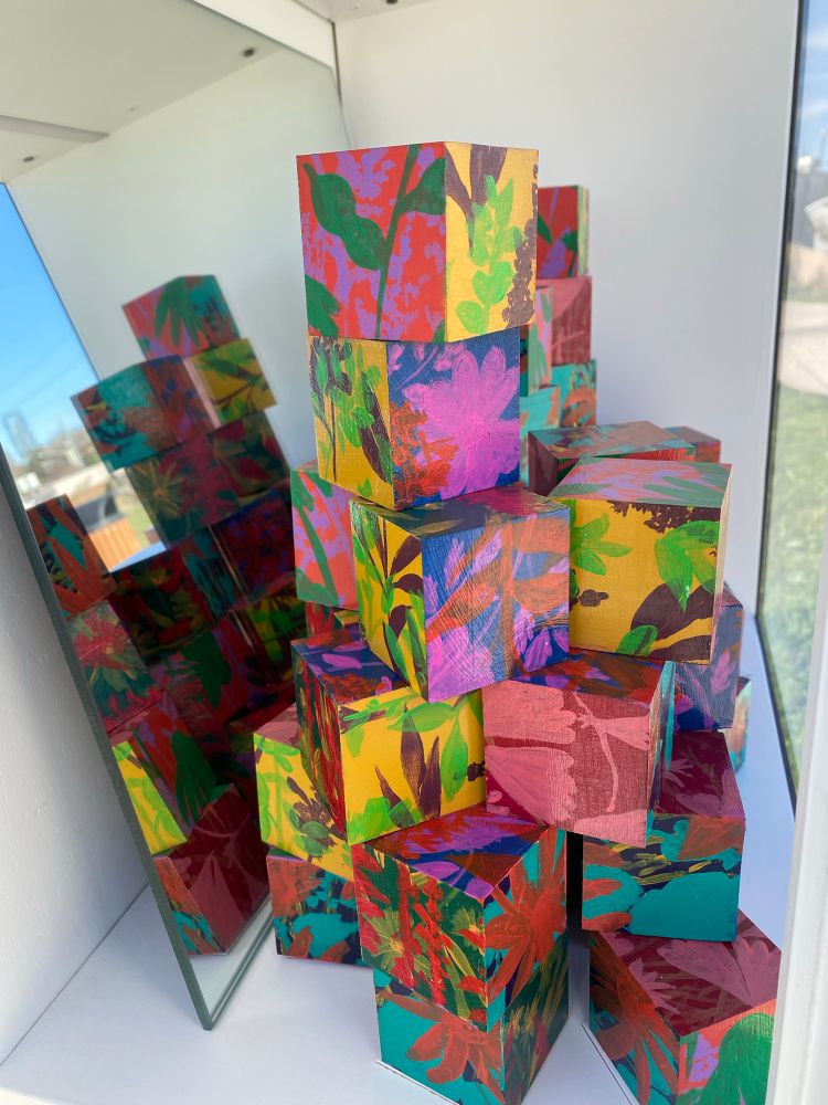 View inside the #reallysmallmuseum in Austin, showing details of flowers and leaves painted on the blocks for the installation of Disappearing Prairies 
