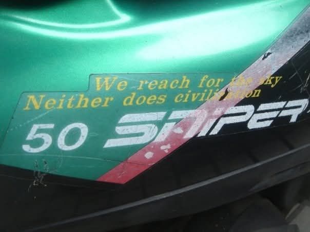 scooter slogan We reach for the sky Neither does civilization  on a green red and black scooter