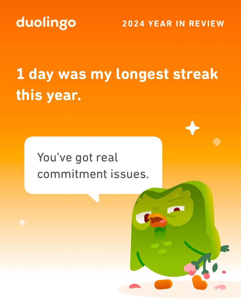 A Duolingo 2024 Year in Review graphic with an orange background. Text reads: “1 day was my longest streak this year.” Below it, the Duolingo owl mascot is holding a bouquet of flowers but looking disappointed. A speech bubble says: “You’ve got real commitment issues.”