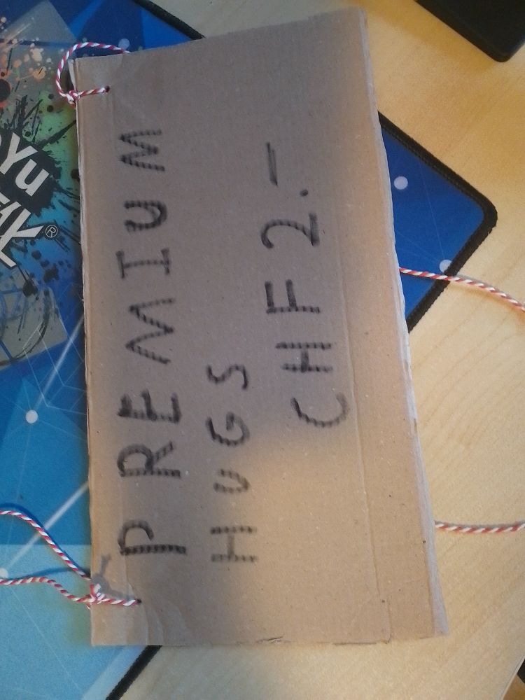 A cardboard sign with "Premium hugs. 2 Swiss Francs" hastily written on.