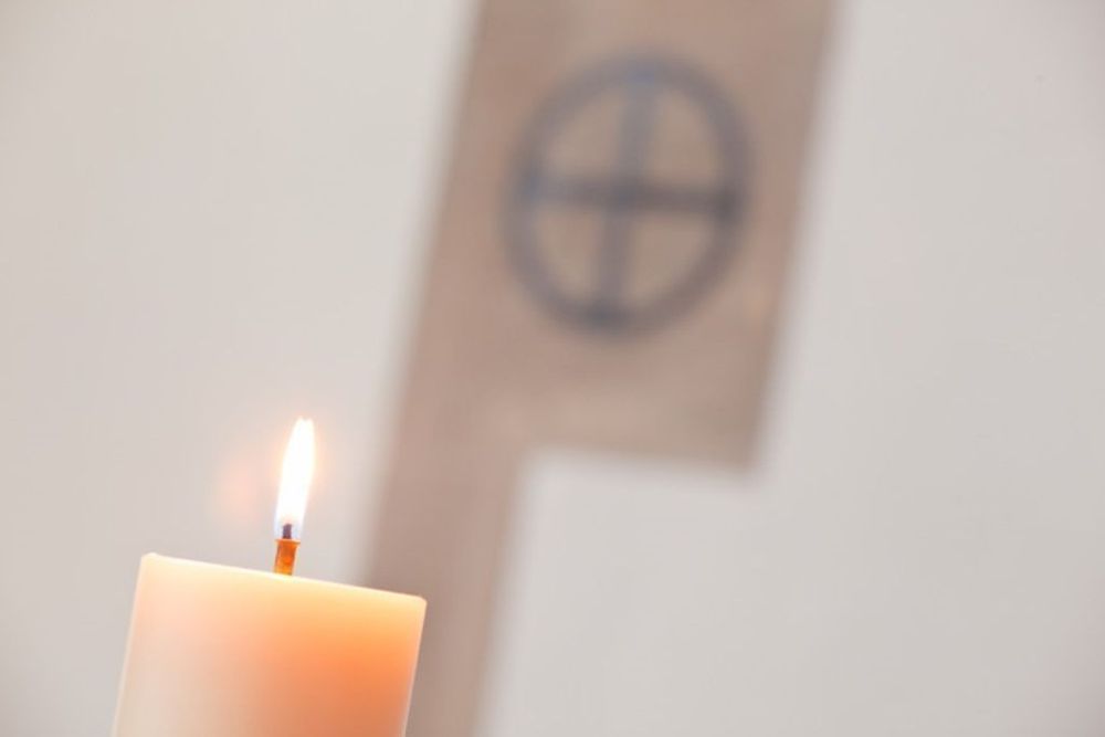 Image of a lighted candle in the chapel of Westcott House. 