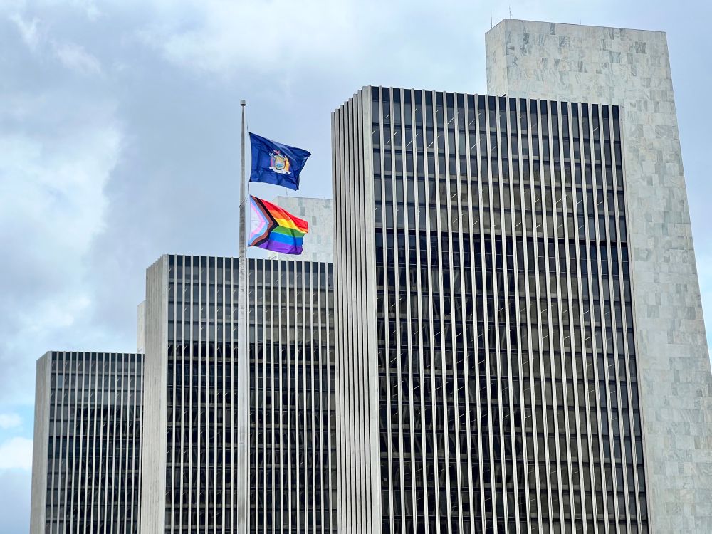 Pride flag and New York State flag flying at Empire State Plaza in Albany, NY