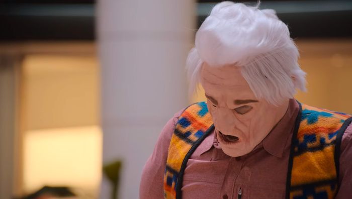 still of guy wearing a horrifying and ill-fitting old man mask from the "there's too much shit on me" I THINK YOU SHOULD LEAVE sketch.