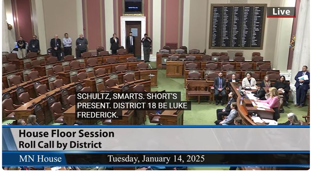 The Minnesota House Chamber. No DFL law makers are in their seats. Just an empty half chamber.