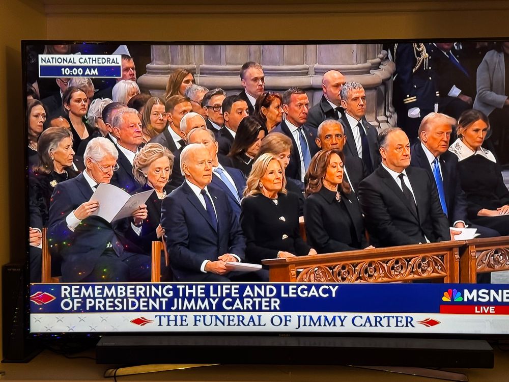 Photo of all the living presidents, vice presidents, and their spouses sitting in pews at President Carter’s funeral.