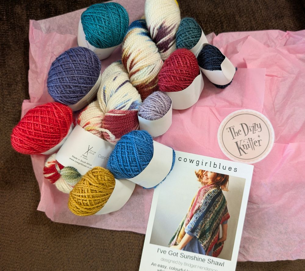 Rainbow colored yarn with a picture of a shawl.