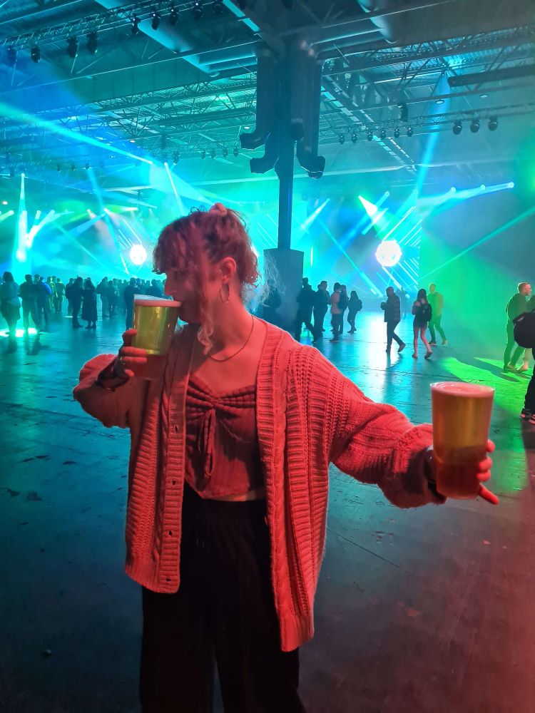 Gilgidane at Runefest, holding two double pints. Sipping from one and struggling to hold the other to the sky in appreciation. Do not separate her from beer.