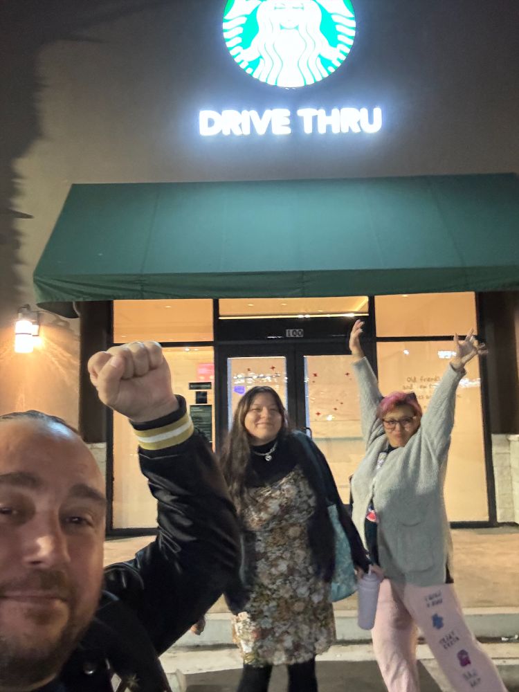 A group of 3 SBWU members and allies support their union victory outside of a Starbucks store
