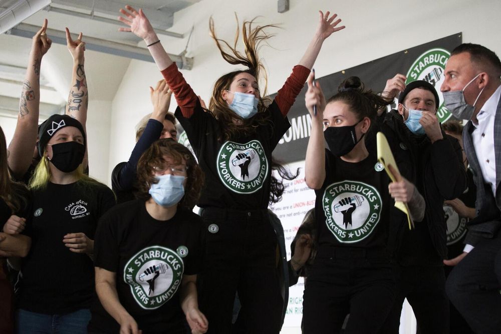 A group of SBWU members celebrating after winning the first Starbucks union in the US