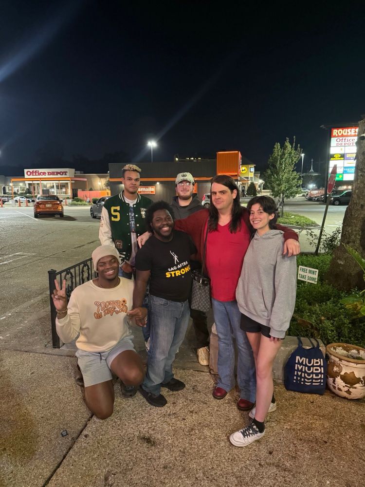 A group of 6 SBWU members and allies support their union victory outside of a Starbucks store