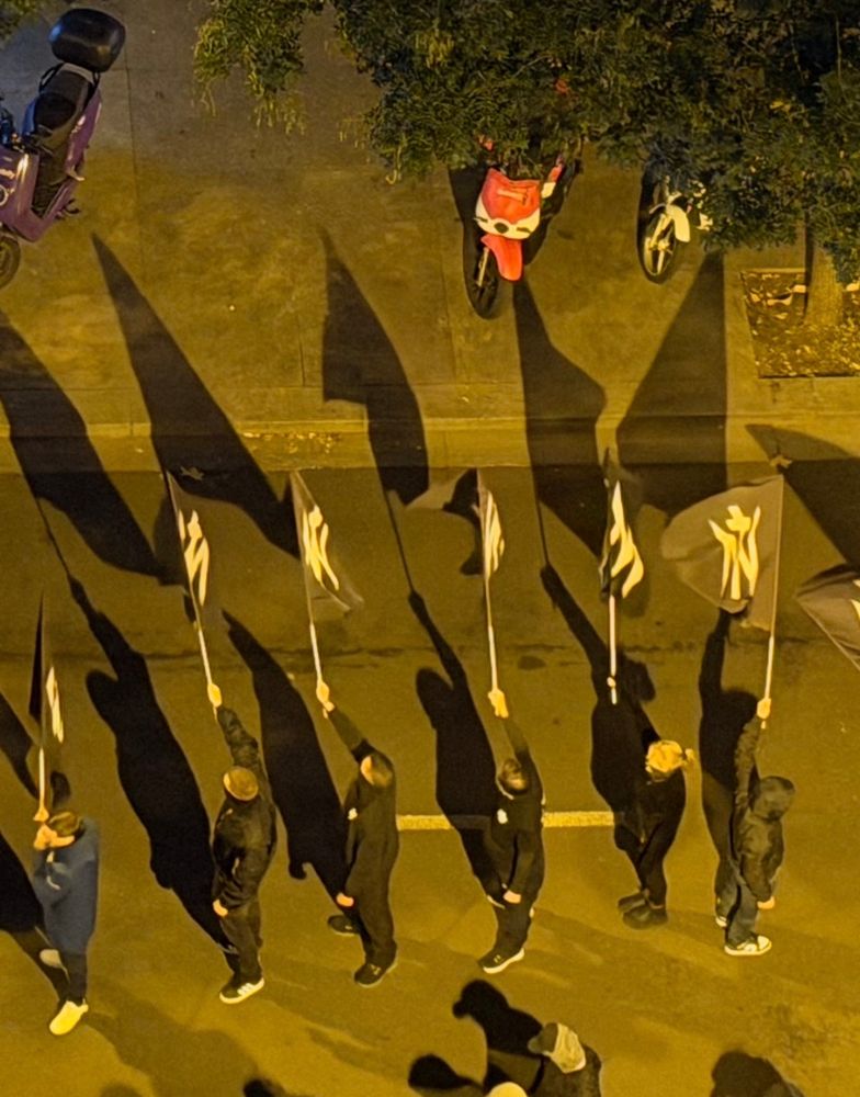 Protesters holding black and white flags 