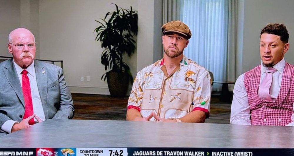 Andy Reid, Travis Kelce, and Patrick Mahomes. Reid is in a gray suit and red tie, Kelce has some weird fucking newsboy cap on and a weird bowling shirt or something, while Mahomes has a snazzy gingham vest and a pink tie. 