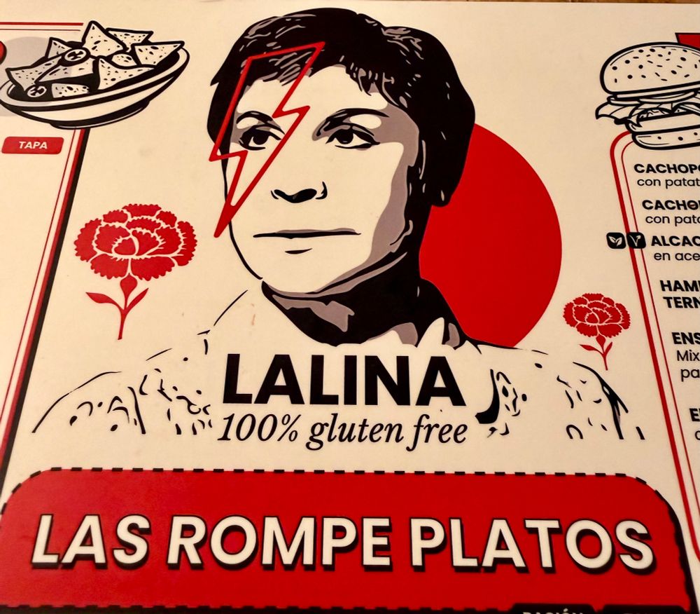 Menu for a 100% gluten free tapas place. Logo is a drawing or a woman with the David Bowie lightning bolt on her face 