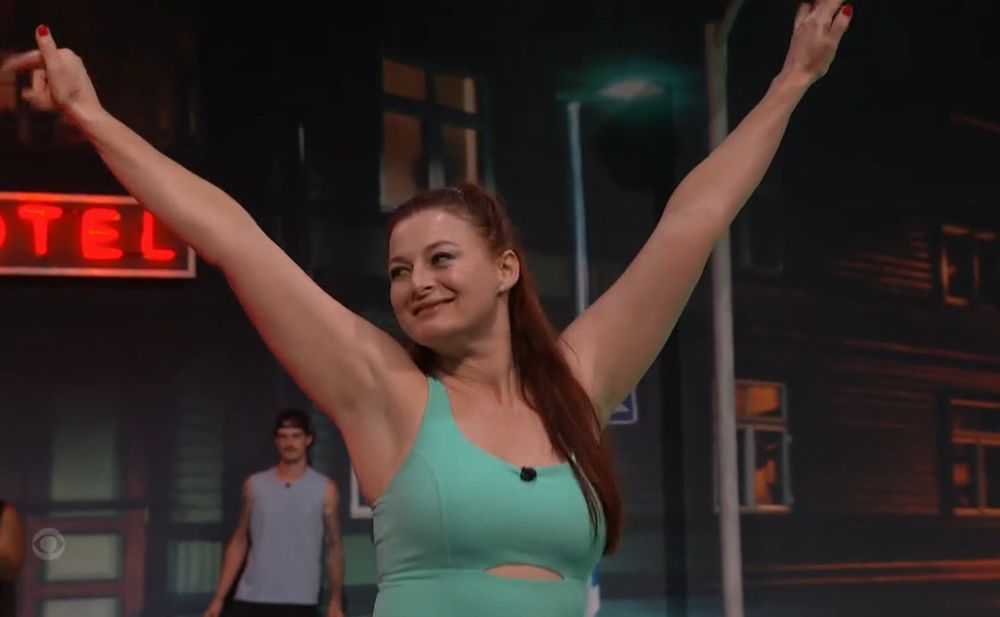 rachel with her hands up smiling bb27. 