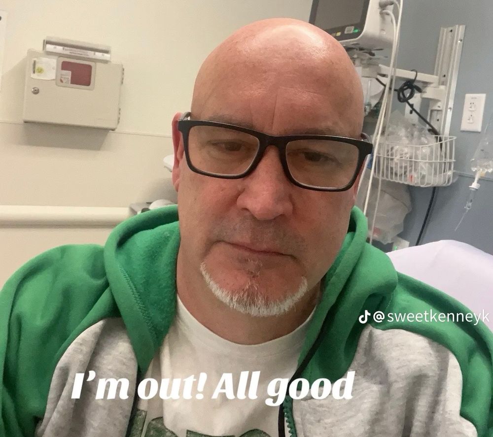 sweet kenney k in the hospital. the text says “i’m out! all good”. 