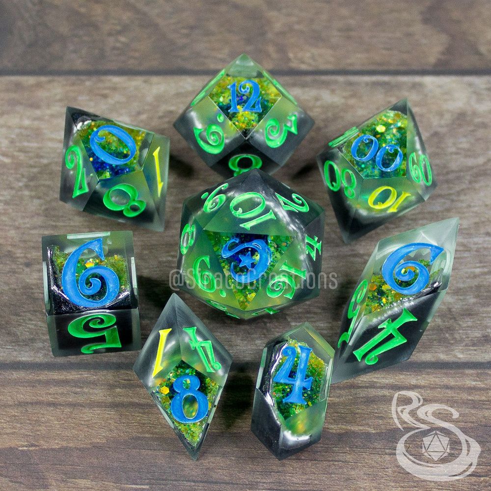 8 Polyhedral geode dice that are inspired by labradorite gemstones. the font on the dice is a magical, whimsical, curly font, and the d20 has a swirling S and star instead of a 20.