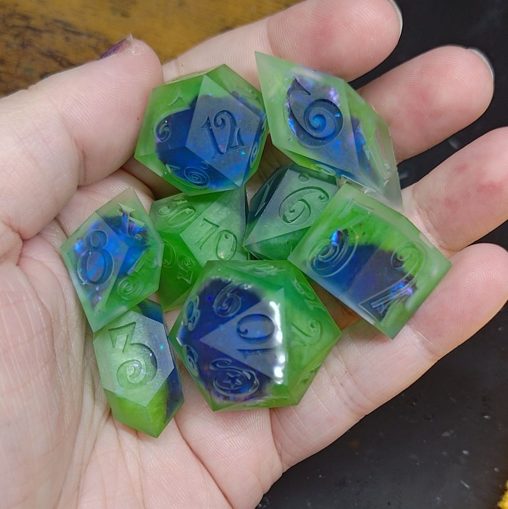 a Polyhedral set of dice, of various shapes and sizes that are meant to look like geodes. 