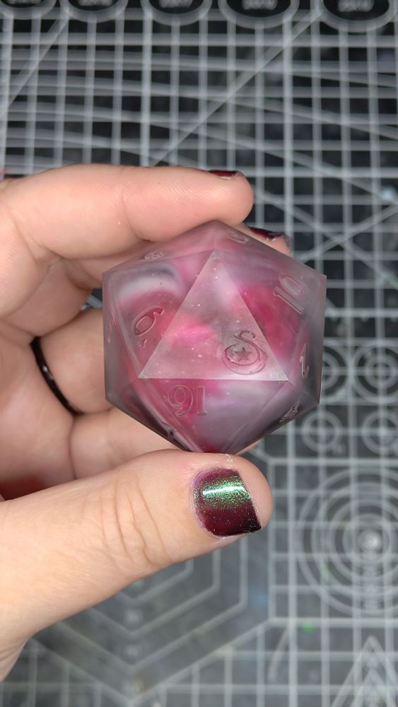 a matte d20 that is 45mm in size. the colors are black, red, and white.