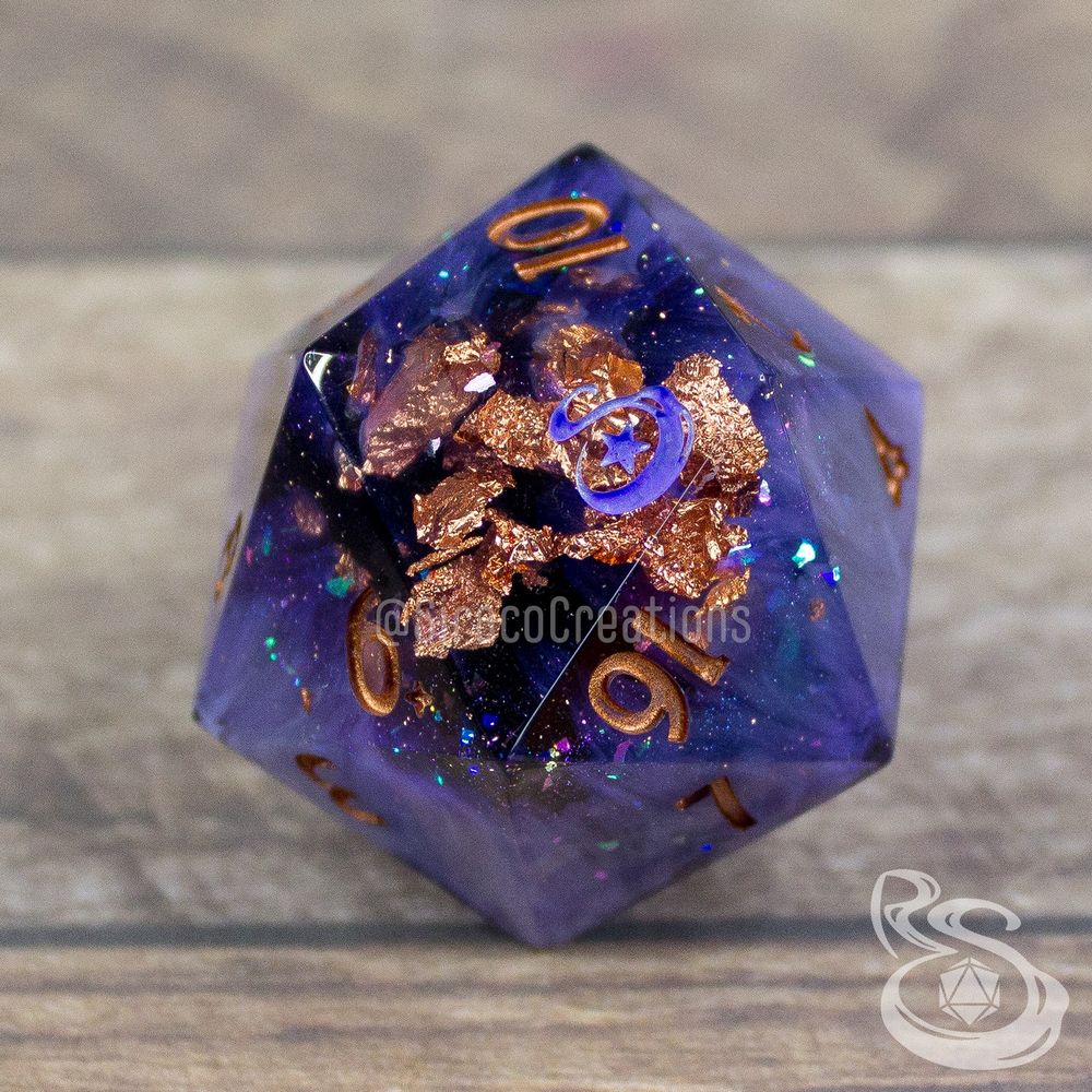 A chonky 45mm D20 with the numbers smaller and in the right hand corner. There are swirls of color, copper flakes, and chameleon flakes. The 20 has been replaced with a stylized S and a star.