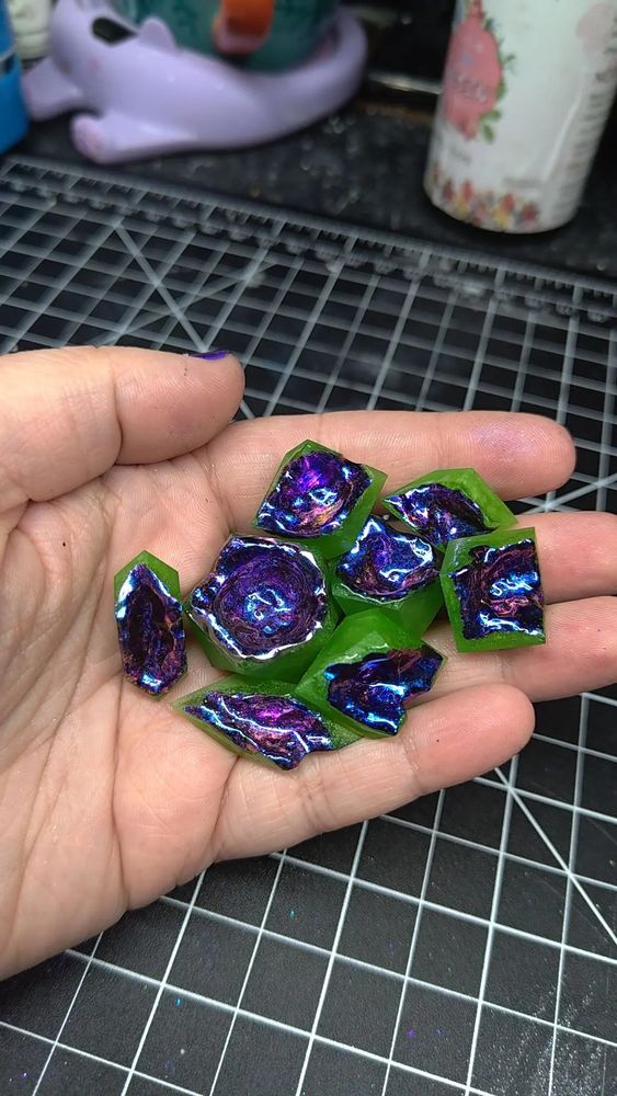 8 Polyhedral blanks of varying shapes and sizes, carved out to resemble geodes. The outer shells are bright lime green, and the centers shift colors between purple and dark blue.