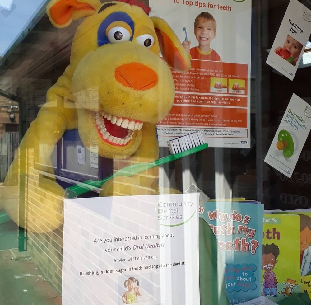 Photo of a horrifying yellow toy dog (maybe) with big human teeth