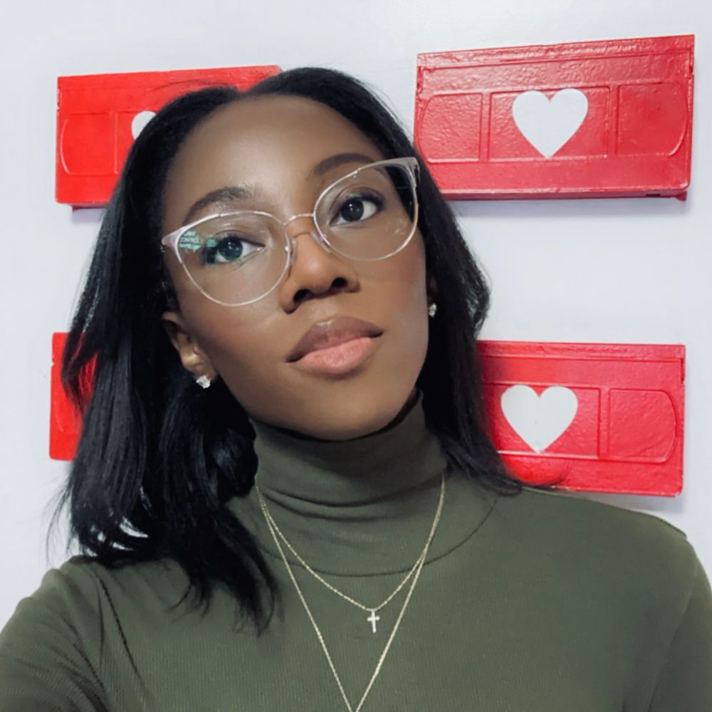 me in front of the heart VHS wall at the Selfie Museum